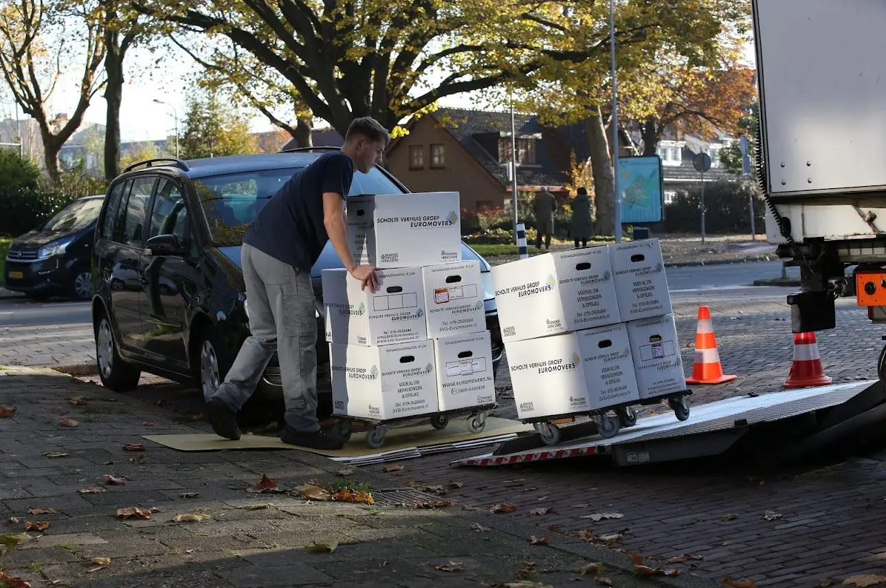 SVG-verhuizer laadt verhuisdozen in de verhuiswagen
